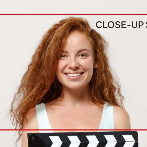 Young smiling redhead woman girl in casual light clothes posing isolated on white background in studio. People lifestyle concept. Mock up copy space. Holding classic black film making clapperboard. Young smiling redhead woman girl in casual light clothes posing isolated on white background in studio. People lifestyle concept. Mock up copy space. Holding classic black film making clapperboard